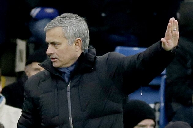 Chelsea's head coach Jose Mourinho holds up his hand before making a substitution during the English Premier League soccer match between Chelsea and West Ham at Stamford Bridge stadium in London, Friday, Dec. 26, 2014.  (AP Photo/Matt Dunham)
