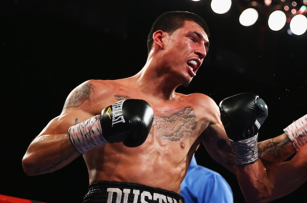 NEW YORK, NY - NOVEMBER 02:  Dusty Hernandez-Harrison punches Josh Torres during their Welterweight fight at The Theater at Madison Square Garden on November 2, 2013 in New York City.  (Photo by Al Bello/Getty Images)