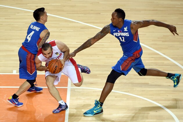 INCHEON, SOUTH KOREA - SEPTEMBER 25:  Mahdi Kamrani of Iran is challenged by June Mar Fajardo of the Philippines during the Basketball Mens Preliminary round match between Iran and the Philippines during day five of the 2014 Asian Games at Hwaseong Sports Complex Gymnasium on September 25, 2014 in Incheon, South Korea.  (Photo by Stanley Chou/Getty Images)