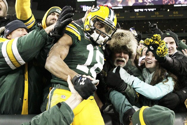 Green Bay Packers' Randall Cobb celebrates with fans after catching a touchdown pass during the second half of an NFL football game against the Detroit Lions Sunday, Dec. 28, 2014, in Green Bay, Wis. (AP Photo/Jim Slosiarek)