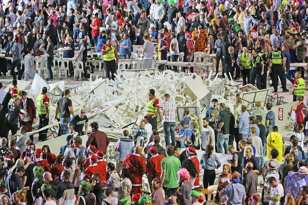 MELBOURNE, AUSTRALIA - JANUARY 10:  Security and police officers stand guard around a pile of plastic chairs and tables after spectators threw them during the final between Simon The Wizard Whitlock and Mighty Michael van Gerwen during the Invitational Darts Challenge at Etihad Stadium on January 10, 2015 in Melbourne, Australia.  (Photo by Scott Barbour/Getty Images)