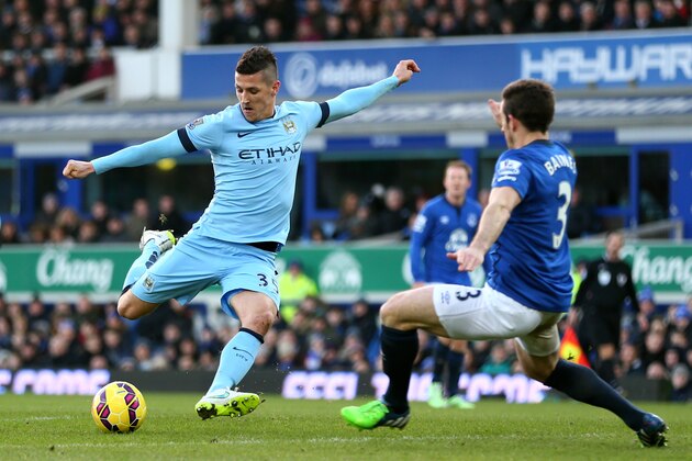 LIVERPOOL, ENGLAND - JANUARY 10:  Stevan Jovetic of Manchester City takes a shot on goal as Leighton Baines of Everton atempts to block during the Barclays Premier League match between Everton and Manchester City at Goodison Park on January 10, 2015 in Liverpool, England.  (Photo by Clive Brunskill/Getty Images)