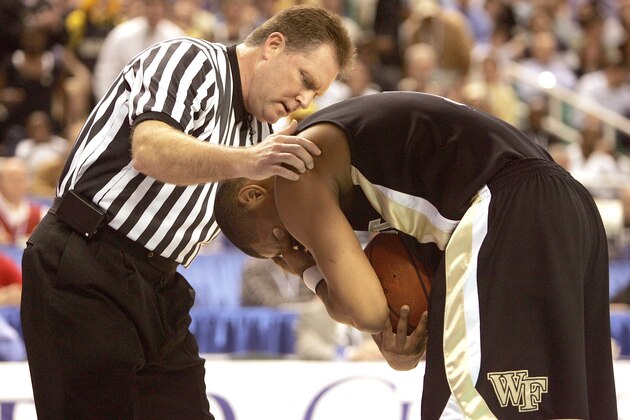 GREENSBORO, NC - MARCH 10:  Official Karl Hess checks on Justin Gray #1 of the Wake Forest Demon Deacons after Gray was hit in the eye against the North Carolina State Wolfpack during the quarterfinals of the Atlantic Coast Conference Men's Basketball Tournament on March 10, 2006 at Greensboro Coliseum in Greensboro, North Carolina.  (Photo By Streeter Lecka/Getty Images)