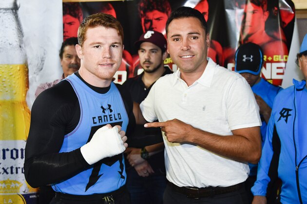 SAN DIEGO, CA - JULY 1:  Canelo Alvarez, former WBC & WBA Super Welterweight World Champion, left, poses for a photo with with Oscar De La Hoya during an open workout at the House of Boxing Gym July 1, 2014 in San Diego, California.  (Photo by Denis Poroy/Getty Images)