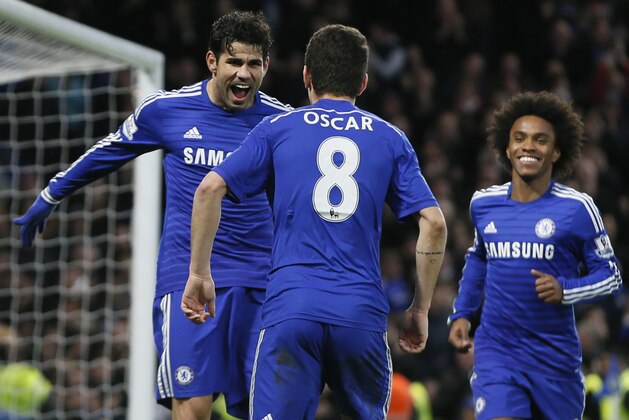 Chelsea's Diego Costa, left, celebrates after scoring his sides second goal during the English Premier League soccer match between Chelsea and Newcastle United at Stamford Bridge stadium in London, Saturday, Jan. 10, 2015. (AP Photo/Alastair Grant)