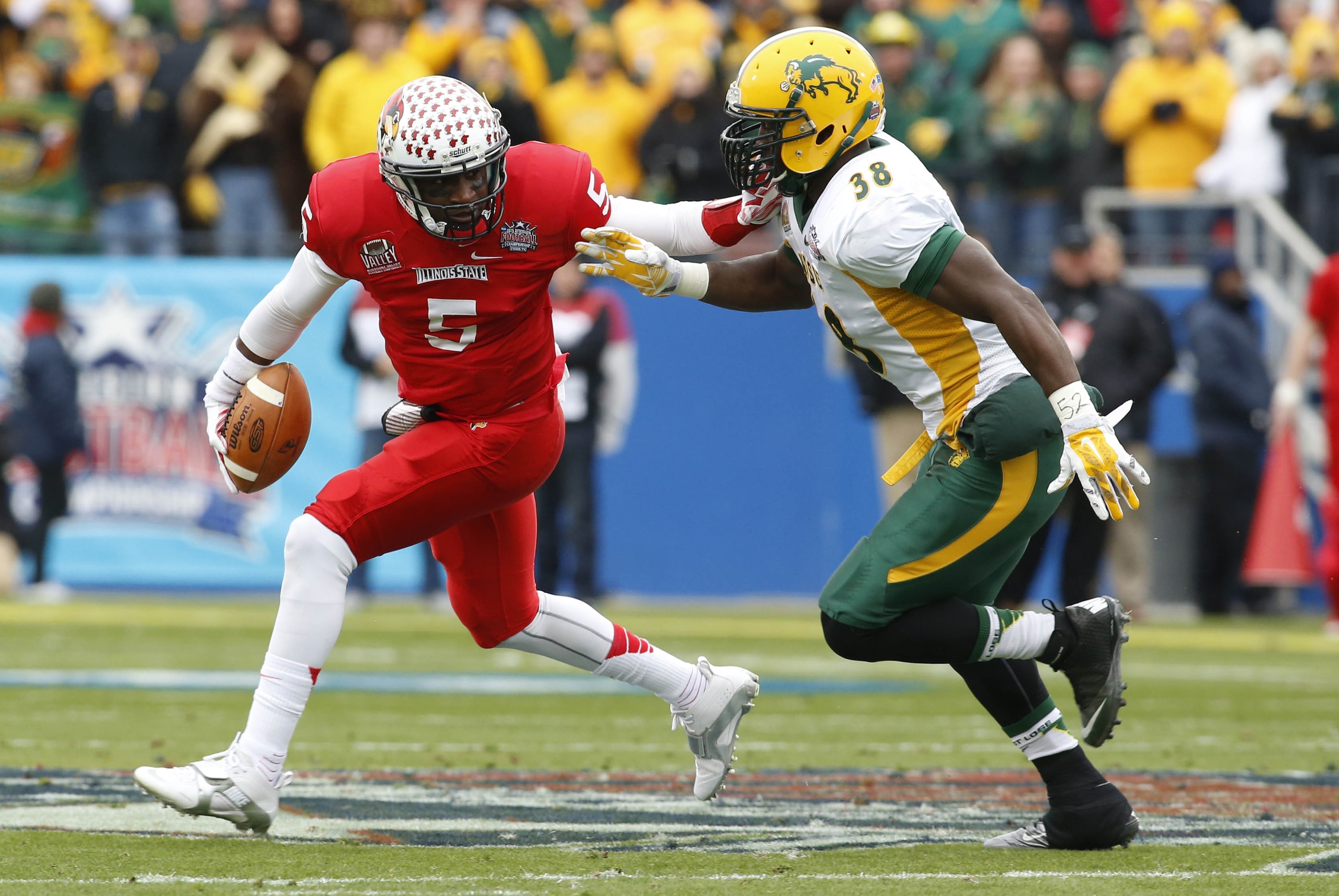 Jan 10, 2015; Frisco, TX, USA; Illinois State Redbirds quarterback Tre Roberson (5) is pursued by North Dakota State Bison linebacker Carlton Littlejohn (38) in the first quarter  of the Division I championship at Pizza Hut Park. Mandatory Credit: Tim Heitman-USA TODAY Sports