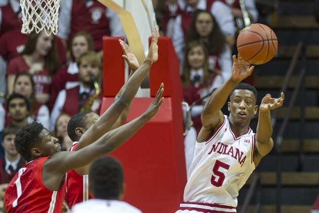 Indiana forward Troy Williams (5) passes the ball off to teammate Kevin Yogi Ferrell (11) after being stopped en route to the basket by the Ohio State defense during the first half of an NCAA college basketball game, Saturday, Jan. 10, 2015, in Bloomington, Ind. (AP Photo/Doug McSchooler)