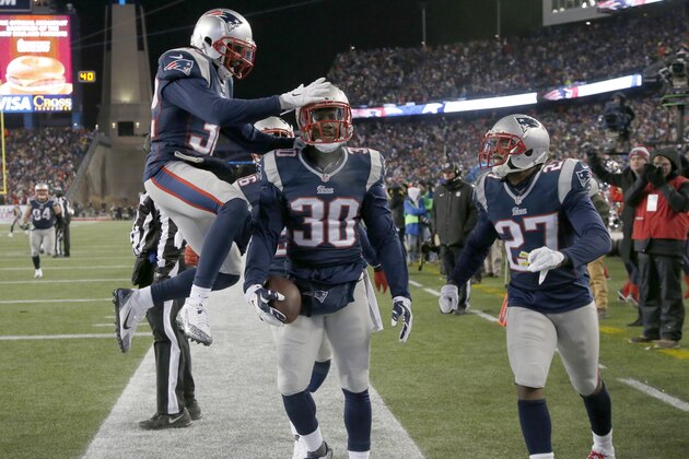 New England Patriots strong safety Duron Harmon (30) celebrates with teammates his interception of a pass by Baltimore Ravens quarterback Joe Flacco in the end zone in the second half of an NFL divisional playoff football game Saturday, Jan. 10, 2015, in Foxborough, Mass. The Patriots won 35-31 to advance to the AFC Championship game. (AP Photo/Elise Amendola)