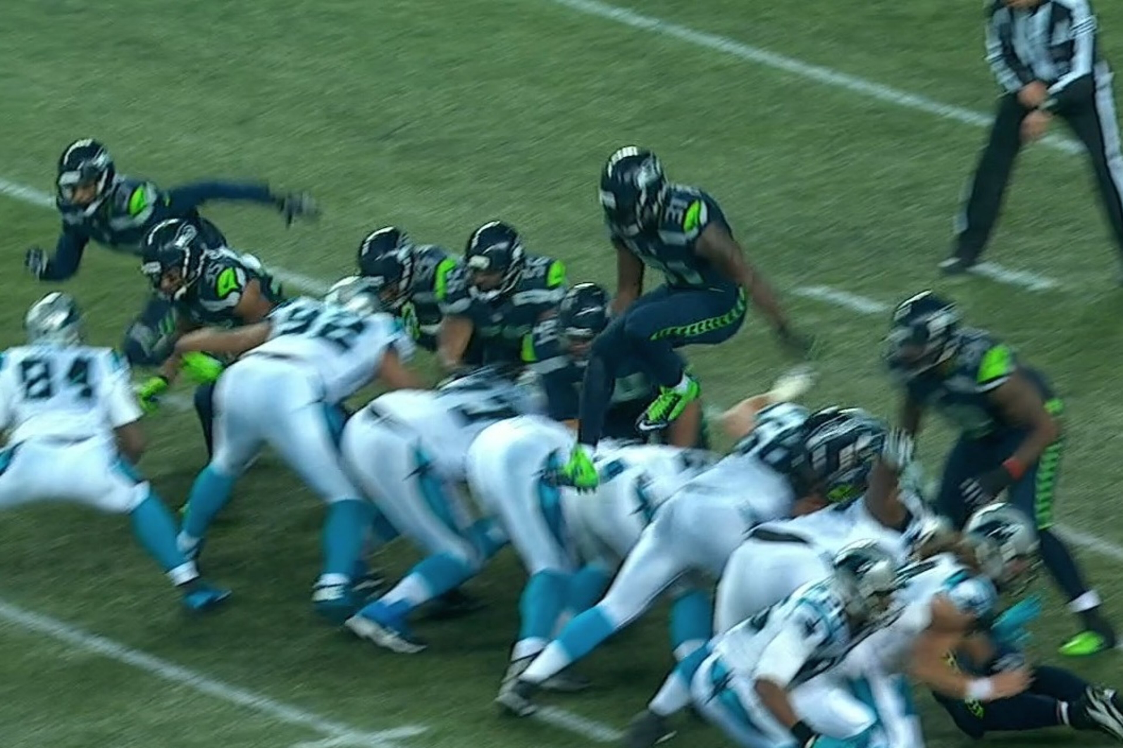 Carolina Panthers running back DeAngelo Williams, right, runs as Seattle Seahawks strong safety Kam Chancellor dives to tackle him during the first half of an NFL divisional playoff football game in Seattle, Saturday, Jan. 10, 2015. (AP Photo/Ted S. Warren)