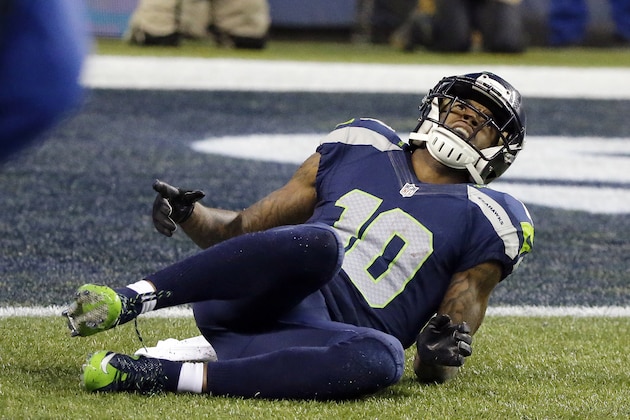 Seattle Seahawks wide receiver Paul Richardson (10) lays on the ground after being injured against the Carolina Panthers during the second half of an NFL divisional playoff football game in Seattle, Saturday, Jan. 10, 2015. (AP Photo/Ted S. Warren)