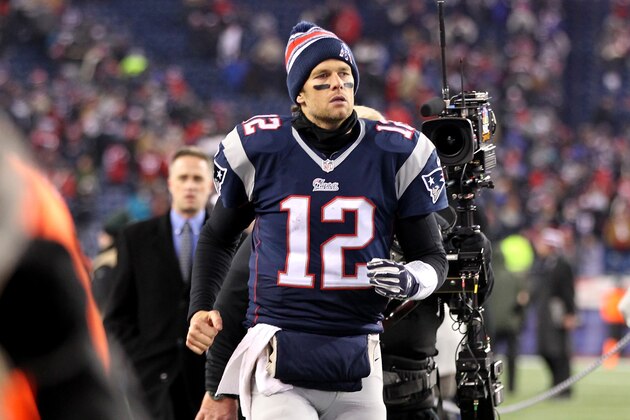 FOXBORO, MA - JANUARY 10:   Tom Brady #12 of the New England Patriots jogs off the field following the 2015 AFC Divisional Playoffs game against the Baltimore Ravens at Gillette Stadium on January 10, 2015 in Foxboro, Massachusetts.  (Photo by Jim Rogash/Getty Images)