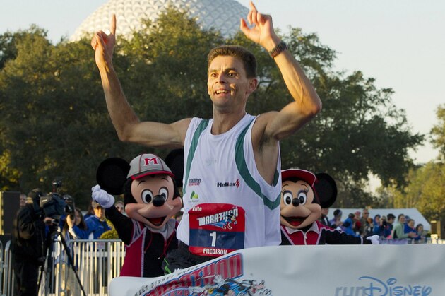 In this photo provided by Disney, Fredison Costa, 34, from Brazil, crosses the finish line to win the annual Walt Disney World Marathon, Sunday, Jan. 8, 2012, at Walt Disney World Resort in Lake Buena Vista, Fla. Costa, who also won last year's Disney Marathon, won this year with an unofficial time of 2:19:01.  The 26.2-mile race, with a field of 26,500 registered runners from all 50 U.S. states and more than 60 international countries, takes athletes through all four Walt Disney World theme parks and several Disney resort hotel areas. (AP Photo/Disney, Matt Stroshane)