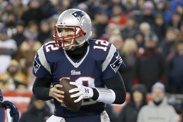 New England Patriots quarterback Tom Brady (12) rolls out to pass against the Baltimore Ravens in the first half of an NFL divisional playoff football game Saturday, Jan. 10, 2015, in Foxborough, Mass. (AP Photo/Elise Amendola)