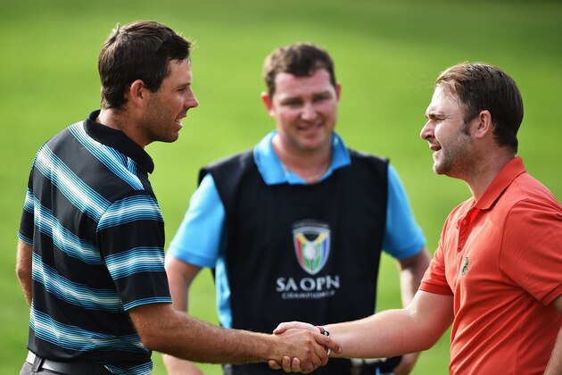 JOHANNESBURG, SOUTH AFRICA - JANUARY 10:  Andy Sullivan of England and Charl Schwartzel of South Africa shake hands during the third round of the South African Open at Glendower Golf Club on January 10, 2015 in Johannesburg, South Africa.  (Photo by Stuart Franklin/Getty Images)