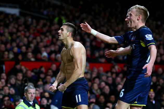 MANCHESTER, ENGLAND - JANUARY 11:  Dusan Tadic of Southampton celebrates with team-mates after scoring the opening goal during the Barclays Premier League match between Manchester United and Southampton at Old Trafford on January 11, 2015 in Manchester, England.  (Photo by Alex Livesey/Getty Images)