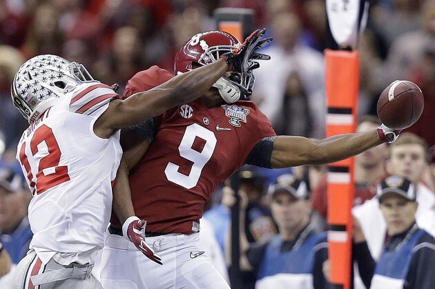Alabama wide receiver Amari Cooper (9) tries to catch the ball as Ohio State cornerback Doran Grant (12) defends during the Sugar Bowl NCAA college football playoff semifinal game, Thursday, Jan. 1, 2015, in New Orleans. (AP Photo/Brynn Anderson)