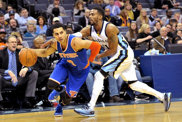 New York Knicks guard Shane Larkin (0) drives past Memphis Grizzlies guard Mike Conley (11) in the first half of an NBA basketball game Monday, Jan. 5, 2015, in Memphis, Tenn. (AP Photo/Brandon Dill)