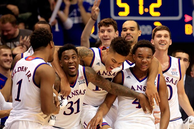 LAWRENCE, KS - JANUARY 10:  Wayne Selden Jr. #1, Jamari Traylor #31, Kelly Oubre Jr. #12 and Devonte Graham #4 of the Kansas Jayhawks celebrate while watching from the bench as Evan Manning #5 of the Kansas Jayhawks sinks a three-pointer during the final minutes of the game against the Texas Tech Red Raiders at Allen Fieldhouse on January 10, 2015 in Lawrence, Kansas.  (Photo by Jamie Squire/Getty Images)