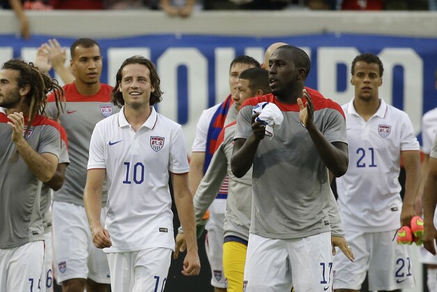 Players of the United States national team including, Kyle Beckerman, far left, Mikkel Diskerud (10), Jozy Altidore (17), Timothy Chandler (21), DeAndre Yedlin (2) and Aron Johannsson (9) walk around the field to cheering fans after defeating Nigeria 2-1 in an international friendly soccer match in Jacksonville, Fla., Saturday, June 7, 2014. The United States won 2-1. (AP Photo/John Raoux)
