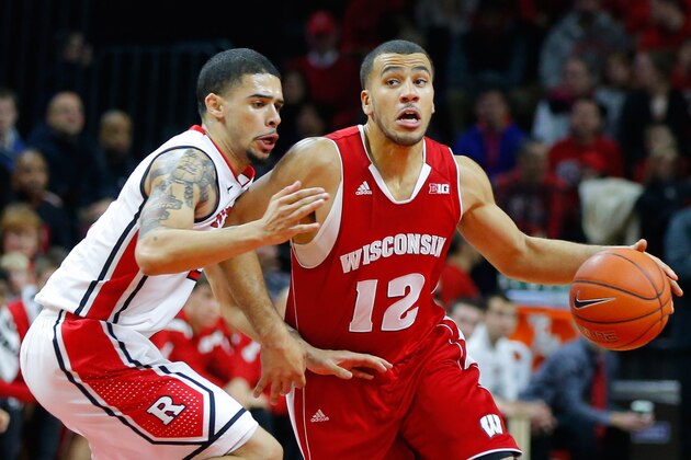 Jan 11, 2015; Piscataway, NJ, USA;  Wisconsin Badgers guard Traevon Jackson (12) works against Rutgers Scarlet Knights guard Bishop Daniels (left) during the first half at Louis Brown Athletic Center. Mandatory Credit: Jim O'Connor-USA TODAY Sports