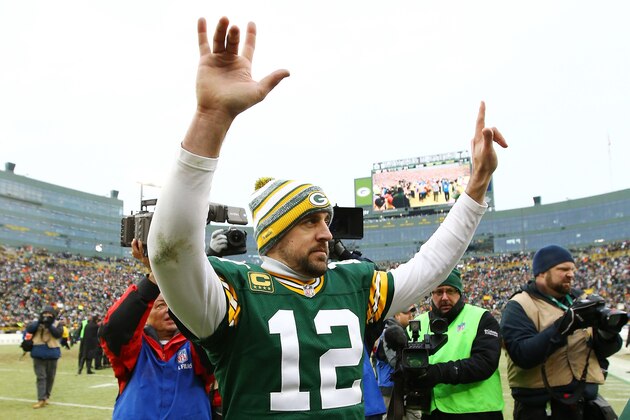 GREEN BAY, WI - JANUARY 11:  Aaron Rodgers #12 of the Green Bay Packers celebrates after defeating the Dallas Cowboys 26-21 during the 2015 NFC Divisional Playoff game at Lambeau Field on January 11, 2015 in Green Bay, Wisconsin.  (Photo by Al Bello/Getty Images)
