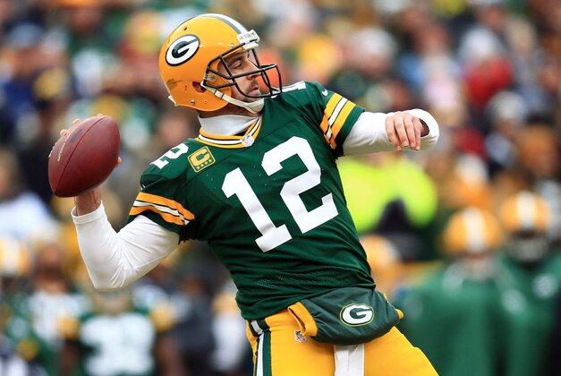 Jan 11, 2015; Green Bay, WI, USA; Green Bay Packers quarterback Aaron Rodgers throws a pass against the Dallas Cowboys in the first half in the 2014 NFC Divisional playoff football game at Lambeau Field. Mandatory Credit: Andrew Weber-USA TODAY Sports