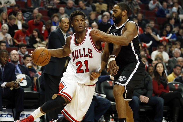 Chicago Bulls guard Jimmy Butler (21) is guarded by Brooklyn Nets guard Alan Anderson (6) during the second half of an NBA basketball game on Tuesday, Dec. 30, 2014, in Chicago. The Nets won 96-82. (AP Photo/Andrew A. Nelles)