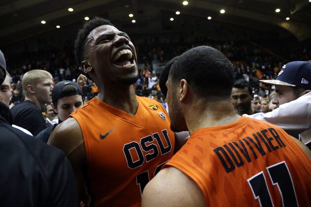 Oregon State guard Langston Morris-Walker, left, celebrates with teammate Malcolm Duvivier after winning an NCAA college basketball game against Arizona in Corvallis, Ore., Sunday, Jan. 11, 2015.  Oregon State beat No. 7-ranked Arizona 58-56. (AP Photo/Don Ryan)