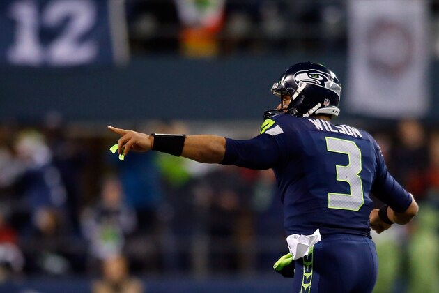 SEATTLE, WA - JANUARY 10:  Russell Wilson #3 celebrates Jermaine Kearse #15 of the Seattle Seahawks 63 yard touchdown in the second quarter against the Carolina Panthers during the 2015 NFC Divisional Playoff game at CenturyLink Field on January 10, 2015 in Seattle, Washington.  (Photo by Jonathan Ferrey/Getty Images)