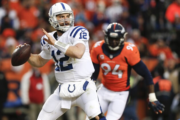Indianapolis Colts quarterback Andrew Luck, left, throws as Denver Broncos defensive end DeMarcus Ware pursues during the first half of an NFL divisional playoff football game, Sunday, Jan. 11, 2015, in Denver. (AP Photo/David Zalubowski)