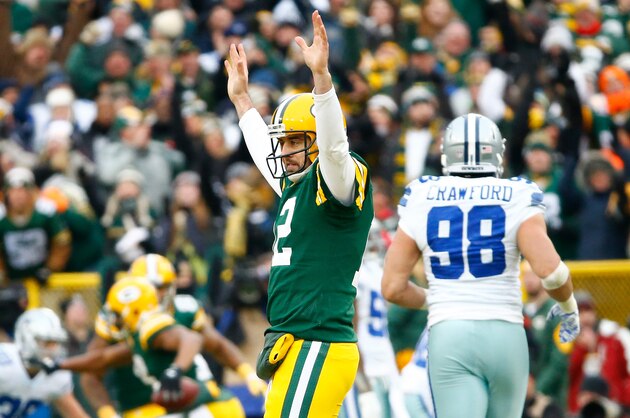 GREEN BAY, WI - JANUARY 11:  Aaron Rodgers #12 of the Green Bay Packers reacts after completing a pass against the Dallas Cowboys during the 2015 NFC Divisional Playoff game at Lambeau Field on January 11, 2015 in Green Bay, Wisconsin.  The Packers defeated the Cowboys 26-21.  (Photo by Al Bello/Getty Images)