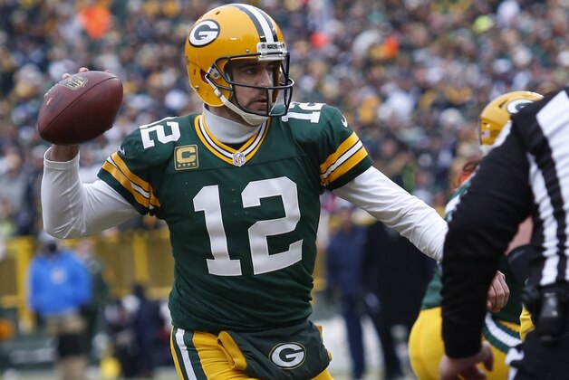 Green Bay Packers quarterback Aaron Rodgers (12) throws a touchdown pass to tight end Andrew Quarless during the first half of an NFL divisional playoff football game against the Dallas Cowboys Sunday, Jan. 11, 2015, in Green Bay, Wis. (AP Photo/Matt Ludtke)