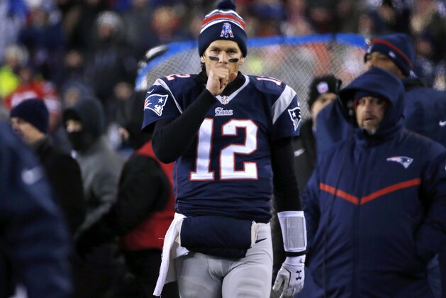 New England Patriots quarterback Tom Brady warms his throwing hand on the sideline in the second half of an NFL divisional playoff football game against the Baltimore Ravens Saturday, Jan. 10, 2015, in Foxborough, Mass. (AP Photo/Elise Amendola)