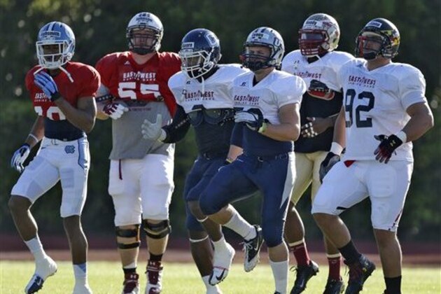 Members of the East Shrine Team run during practice Tuesday, Jan. 15, 2013, in St. Petersburg, Fla. The East squad will take on the West in the East West Shrine college football game on Saturday afternoon. (AP Photo/Chris O'Meara)