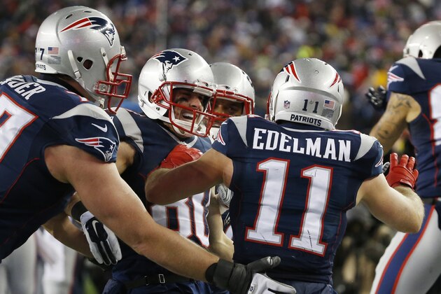 New England Patriots wide receiver Danny Amendola, center, celebrates his 51-yard touchdown pass from Julian Edelman (11) in the second half of an NFL divisional playoff football game against the Baltimore Ravens Saturday, Jan. 10, 2015, in Foxborough, Mass. (AP Photo/Elise Amendola)