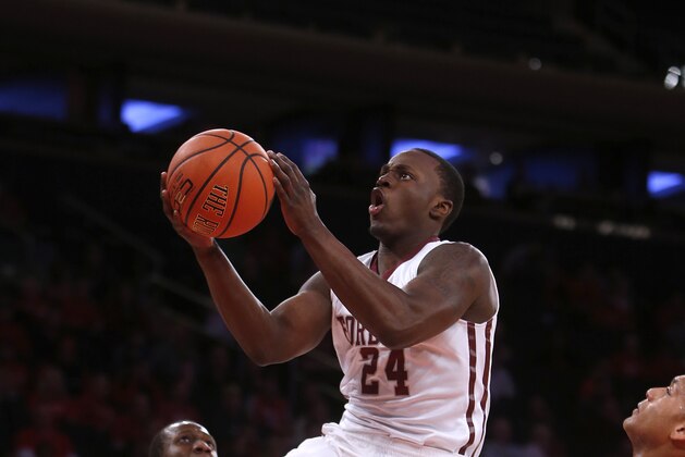 Fordham's Bryan Smith (24) goes to the basket against St. John's during the first half of an NCAA college basketball game Sunday, Dec. 14, 2014, in New York.  St. John's beat Fordham 74-53. (AP Photo/Jason DeCrow)