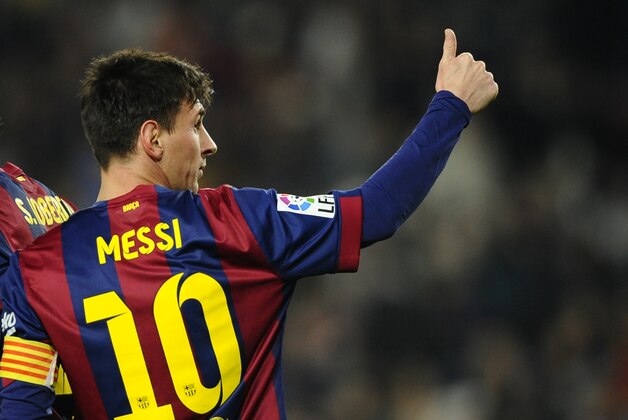 FC Barcelona's  Lionel Messi, from Argentina, gestures after scoring against Elche during a round of 16 first leg Copa del Rey soccer match at the Camp Nou stadium in Barcelona, Spain, Thursday, Jan. 8, 2015. (AP Photo/Manu Fernandez)