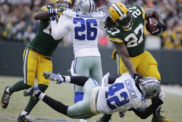 Green Bay Packers running back Eddie Lacy (27) is tackled by Dallas Cowboys strong safety Barry Church (42) during the second half of an NFL divisional playoff football game Sunday, Jan. 11, 2015, in Green Bay, Wis. (AP Photo/Nam Y. Huh)