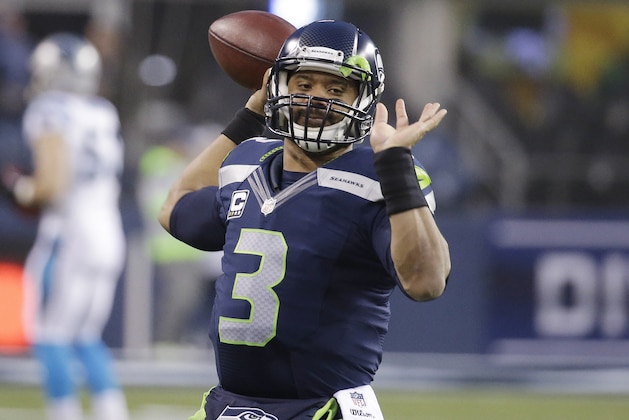 Seattle Seahawks quarterback Russell Wilson (3) throws during warmups before an NFL divisional playoff football game against the Carolina Panthers in Seattle, Saturday, Jan. 10, 2015. (AP Photo/Elaine Thompson)