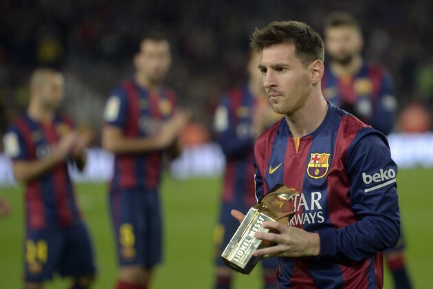 FC Barcelona's Lionel Messi, from Argentina, is awarded a trophy by the Spanish La Liga for setting a goal scoring record, prior to the Spanish La Liga soccer match between FC Barcelona and Atletico Madrid at the Camp Nou stadium in Barcelona, Spain, Sunday, Jan. 11, 2015. (AP Photo/Manu Fernandez)