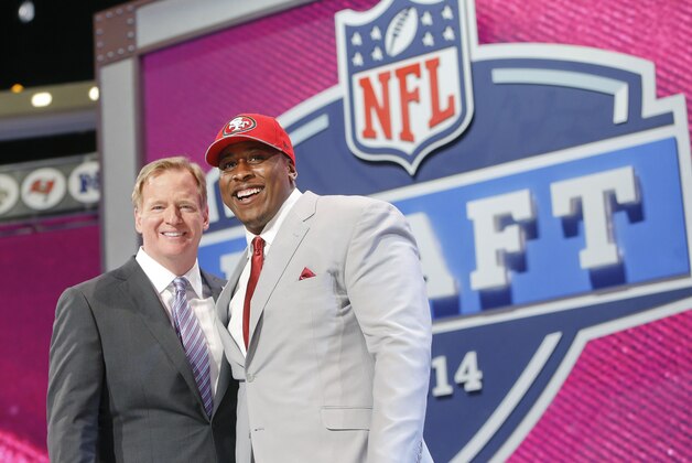 USC center Marcus Martin poses for photos with NFL commissioner Roger Goodell after being selected as the 70th pick by the San Francisco 49ers in the third round of the 2014 NFL Draft, Friday, May 9, 2014, in New York. (AP Photo/Jason DeCrow)