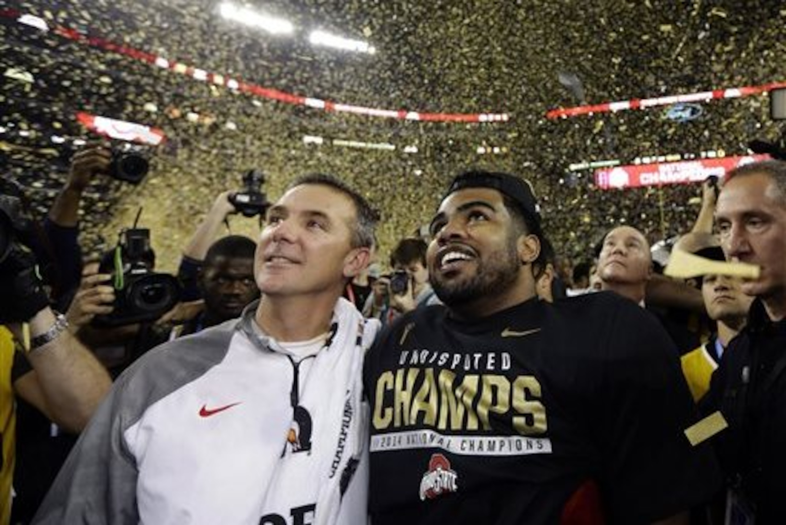 CORRECTS PLAYER AT RIGHT  TO EZEKIEL ELLIOTT- Ohio State head coach Urban Meyer and Ezekiel Elliott celebrate after the NCAA college football playoff championship game against Oregon Monday, Jan. 12, 2015, in Arlington, Texas. Ohio State won 42-20. (AP Photo/David J. Phillip)