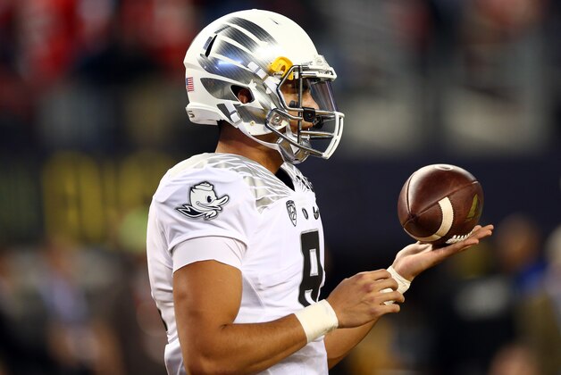ARLINGTON, TX - JANUARY 12:  Quarterback Marcus Mariota #8 of the Oregon Ducks warms up prior to the College Football Playoff National Championship Game against the Ohio State Buckeyes at AT&T Stadium on January 12, 2015 in Arlington, Texas.  (Photo by Ronald Martinez/Getty Images)