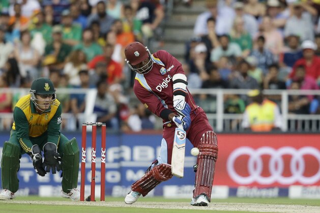 West Indies’s batsman Marlon Samuels, right, plays a shot as South Africa’s wicketkeeper Morne van Wyk, left, watches during their 2nd T20 cricket match at the Wanderers stadium in Johannesburg, South Africa, Sunday, Jan. 11, 2015. (AP Photo/Themba Hadebe)