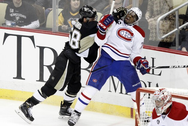 Pittsburgh Penguins' Kris Letang (58) checks Montreal Canadiens' P.K. Subban (76) during the third period of an NHL hockey game in Pittsburgh Saturday, Jan. 3, 2015.(AP Photo/Tom E. Puskar)