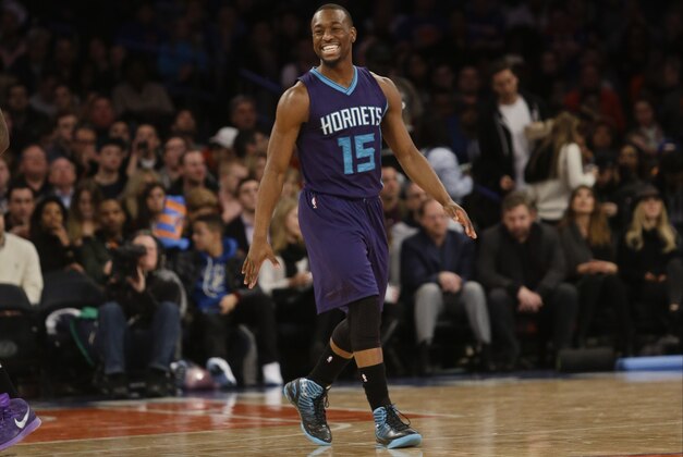 Charlotte Hornets' Kemba Walker (15) smiles after making a 3-point basket during the first half of an NBA basketball game against the New York Knicks, Saturday, Jan. 10, 2015, in New York. (AP Photo/Frank Franklin II)