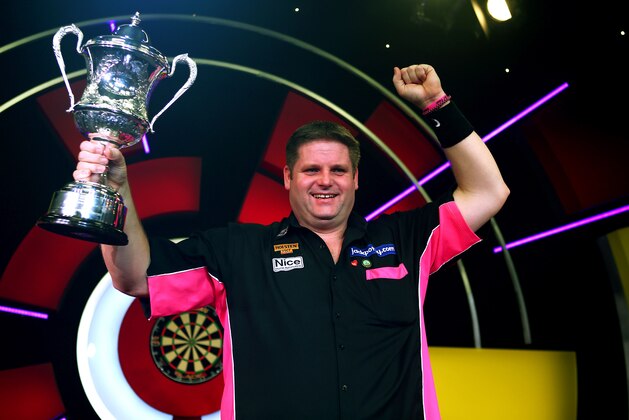 FRIMLEY, ENGLAND - JANUARY 11: Scott Mitchell of England celebrates with the trophy after winning the mens final against Martin Adams of England during the BDO Lakeside World Professional Darts Championships on Day Nine at The Lakeside Country Club on January 11, 2015 in Frimley, England. (Photo by Charlie Crowhurst/Getty Images)