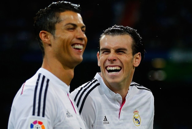 MADRID, SPAIN - NOVEMBER 08: Cristiano Ronaldo (L) of Real Madrid CF joke swith his teammate Gareth Bale prior to start the La Liga match between Real Madrid CF and Rayo Vallecano de Madrid at Estadio Santiago Bernabeu on November 8, 2014 in Madrid, Spain. (Photo by Gonzalo Arroyo Moreno/Getty Images) MADRID, SPAIN - NOVEMBER 08: Cristiano Ronaldo (L) of Real Madrid CF joke swith his teammate Gareth Bale prior to start the La Liga match between Real Madrid CF and Rayo Vallecano de Madrid at Estadio Santiago Bernabeu on November 8, 2014 in Madrid, Spain. (Photo by Gonzalo Arroyo Moreno/Getty Images)