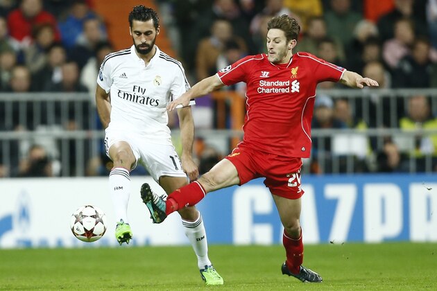 Real Madrid's Alvaro Arbeloa, left, challenges Liverpool's Adam Lallana during a Group B Champions League soccer match between Real Madrid and Liverpool at the Santiago Bernabeu stadium in Madrid, Spain, Tuesday Nov. 4, 2014. (AP Photo/Andres Kudacki)