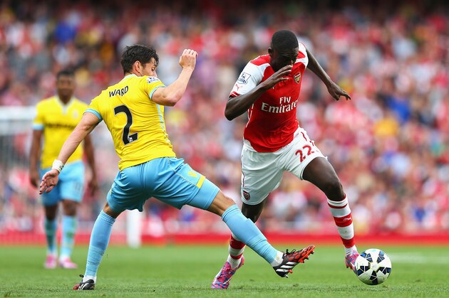 LONDON, ENGLAND - AUGUST 16: Yaya Sanogo of Arsenal goes past Joel Ward of Crystal Palace during the Barclays Premier League match between Arsenal and Crystal Palace at Emirates Stadium on August 16, 2014 in London, England.  (Photo by Clive Mason/Getty Images)